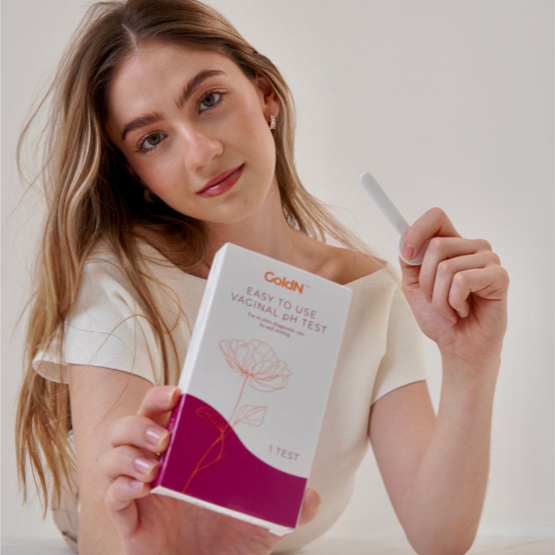 Young woman holding the GoldN™ Easy To Use Vaginal pH Test (1 Count)