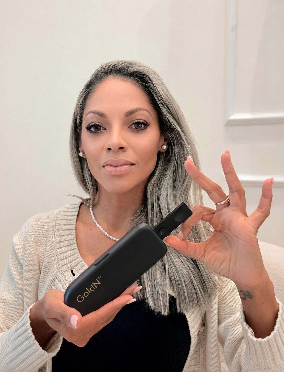 Nancy Torres holding a GoldN case in soft light